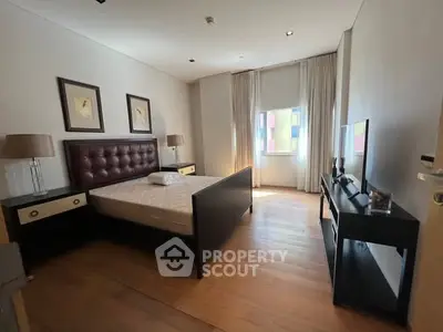 Spacious bedroom with elegant furnishings and natural light, perfect for relaxation and comfort.