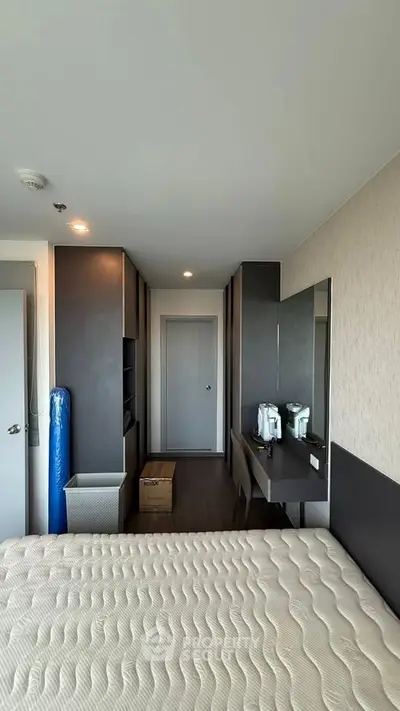 Modern bedroom with sleek furniture and ample storage space
