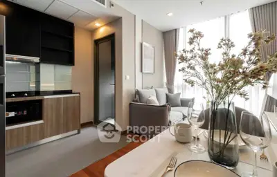Modern open-plan kitchen and living area with stylish decor and natural light.