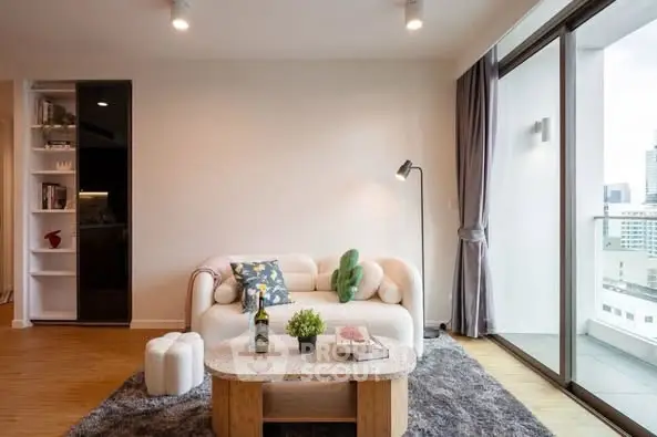 Modern living room with cozy sofa and city view balcony