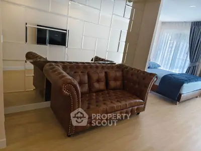 Luxurious living room with elegant leather sofa and mirrored wall accent