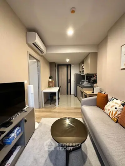 Modern living room with open kitchen layout and stylish decor