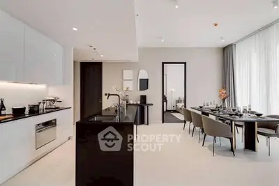Luxurious open-plan kitchen and dining area with modern design and elegant furnishings.