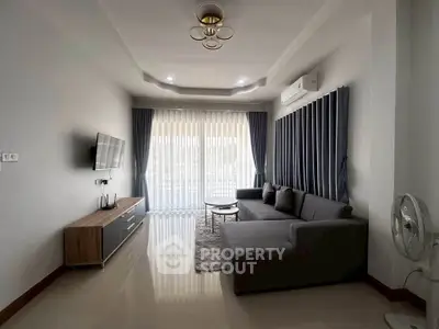 Modern living room with sleek furniture and large windows for natural light.