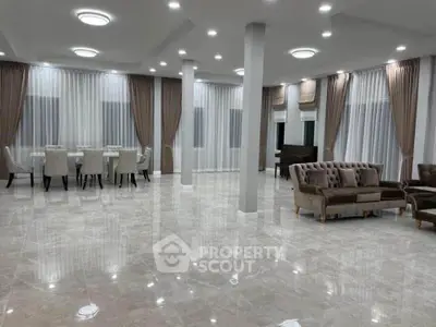 Spacious luxury living room with elegant furniture and marble flooring