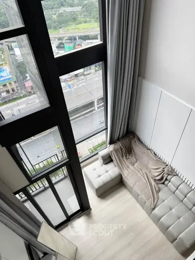 Modern high-rise apartment with floor-to-ceiling windows and stunning city view