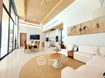 Luxurious open-plan living room with modern decor and high ceilings, featuring a cozy seating area and elegant dining space.