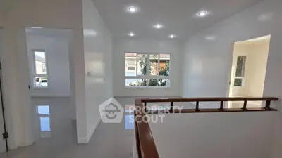 Spacious and bright interior with modern finishes and large windows in a residential property.