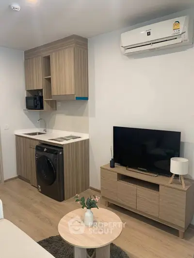 Modern compact living room with integrated kitchen and stylish wooden furniture