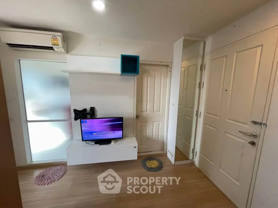 Modern living room with TV, air conditioning, and stylish decor