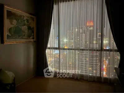 Stunning city view from high-rise apartment with floor-to-ceiling windows and elegant decor.