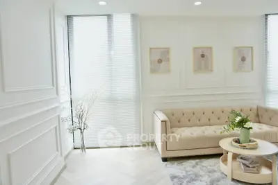 Elegant living room with plush sofa, modern decor, and natural light