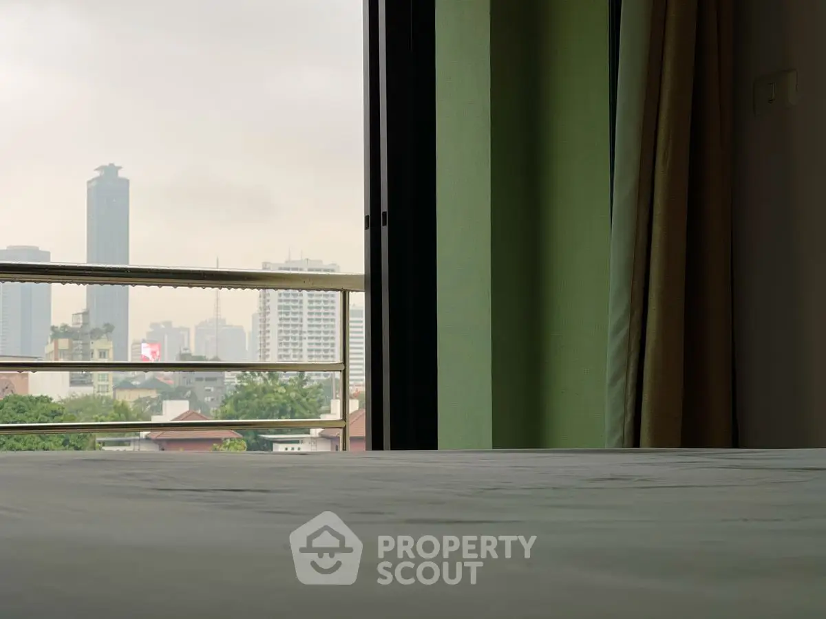 City view from a modern apartment balcony with skyline backdrop.