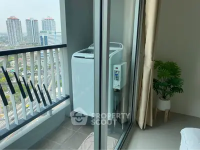 Modern high-rise apartment balcony with washing machine and city view