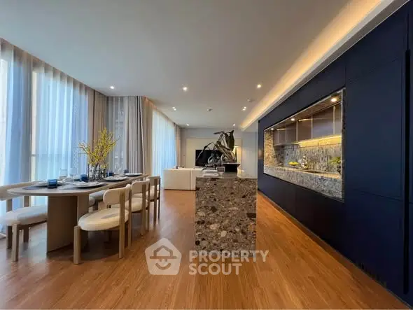 Luxurious open-plan living and dining area with elegant decor and modern kitchen.