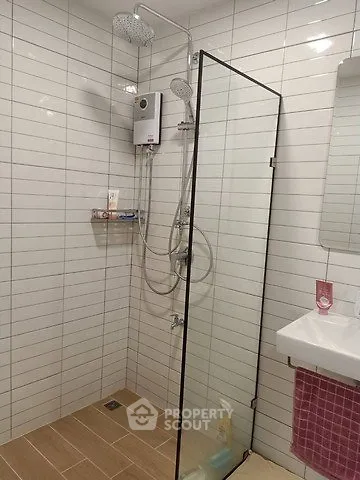 Modern bathroom with glass shower enclosure and sleek fixtures