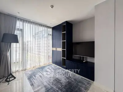 Modern living room with large window and stylish blue cabinetry