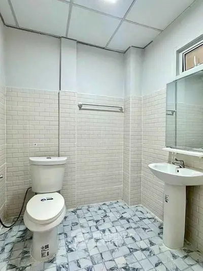 Modern bathroom with white tiles and pedestal sink
