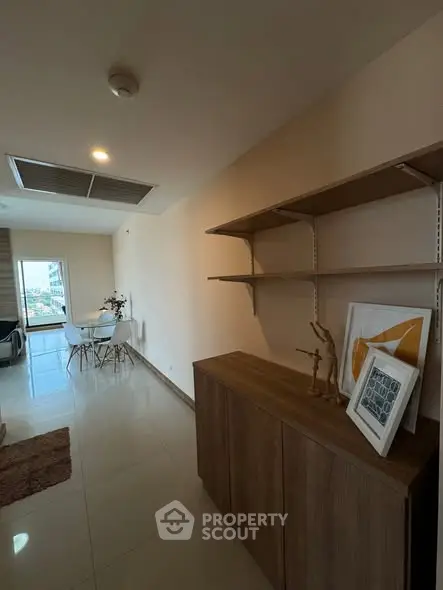 Modern apartment hallway with stylish decor and dining area view