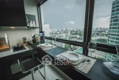 Modern kitchen with stunning city view, sleek countertops, and elegant dining setup.