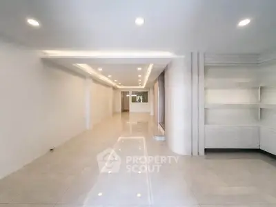 Spacious modern interior with sleek lighting and tiled flooring, perfect for versatile living or office space.