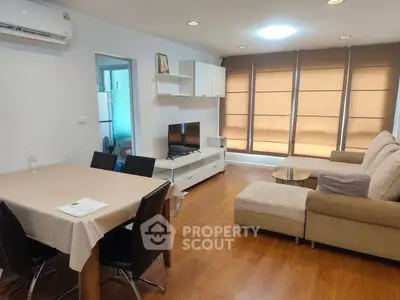 Spacious living room with modern furniture and large windows in a stylish apartment.