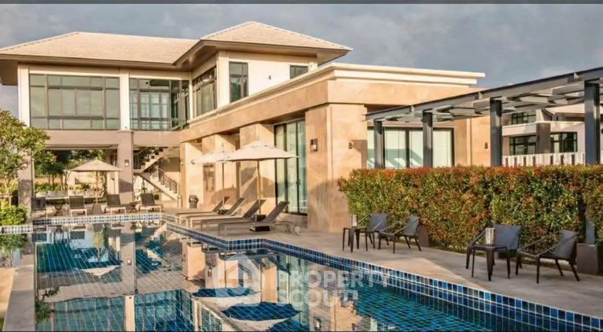 Luxurious modern villa with private pool and elegant outdoor seating area.