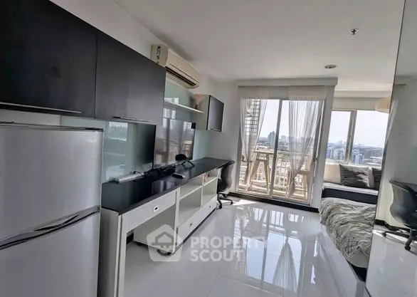 Modern apartment with sleek kitchen and stunning city view from balcony.