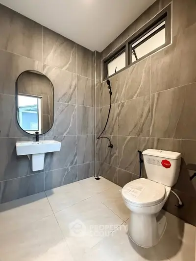 Modern bathroom with sleek gray tiles and contemporary fixtures