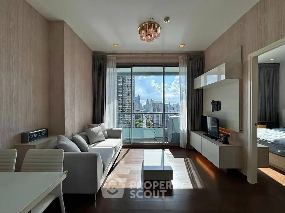 Modern living room with city view and balcony access in a high-rise apartment.