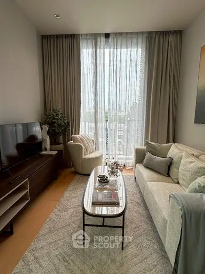 Cozy living room with modern decor and large window for natural light.