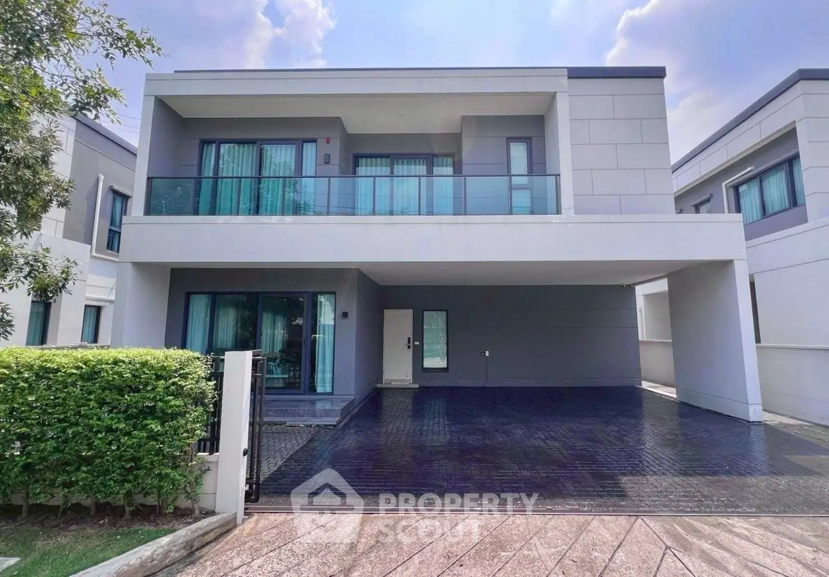 Modern two-story house with spacious driveway and balcony