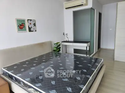 Modern bedroom with minimalist decor and air conditioning in a stylish apartment.