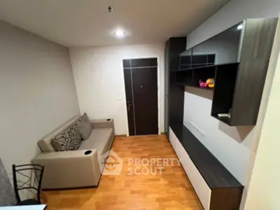 Modern living room with sleek furniture and wooden flooring, perfect for cozy urban living.