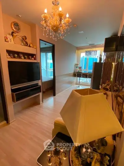 Luxurious living room with chandelier and modern decor in high-rise apartment