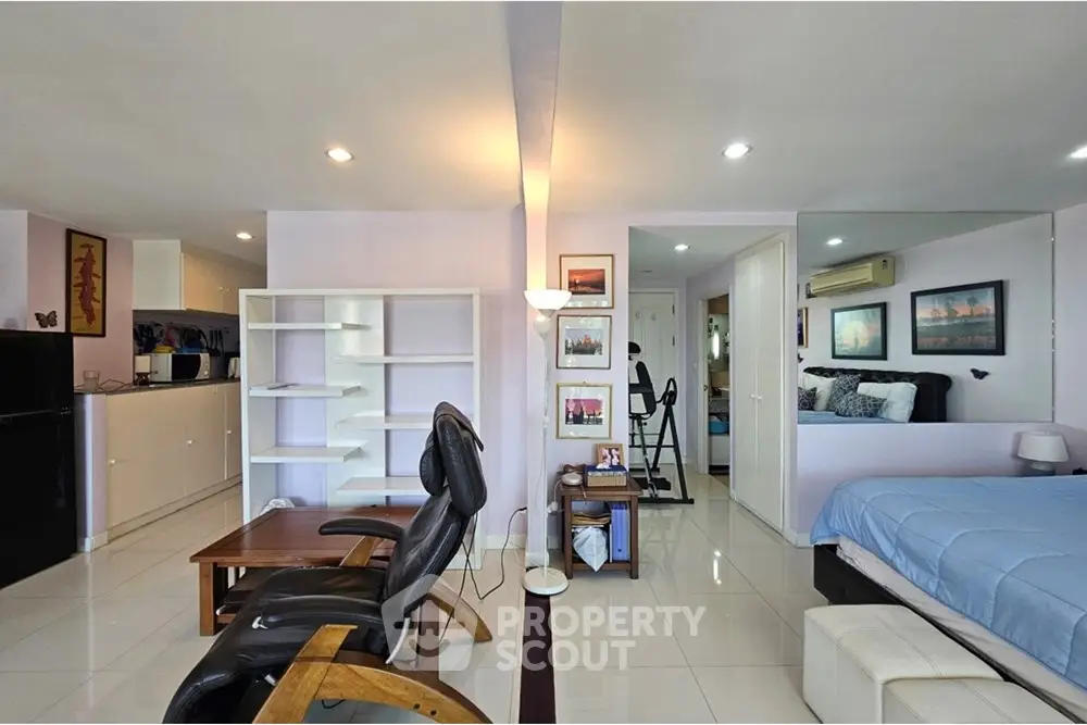 Spacious modern living area with open layout and stylish furnishings in a bright apartment.