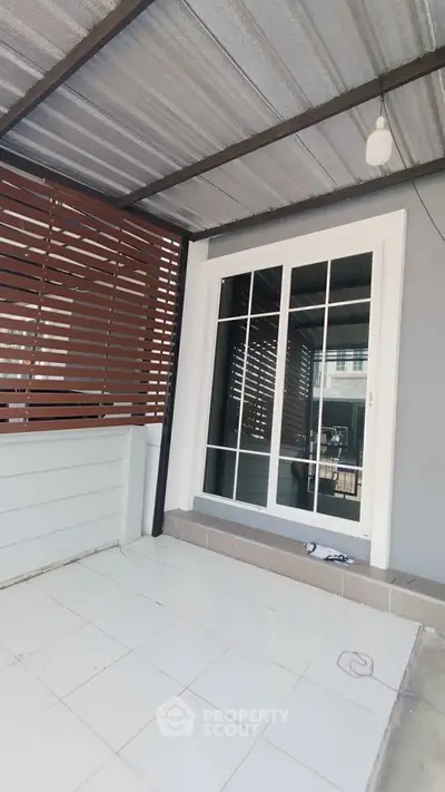 Modern patio with sliding glass doors and stylish wooden paneling