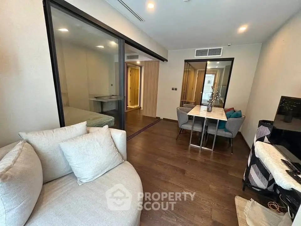 Modern living room with dining area and glass partition in stylish apartment