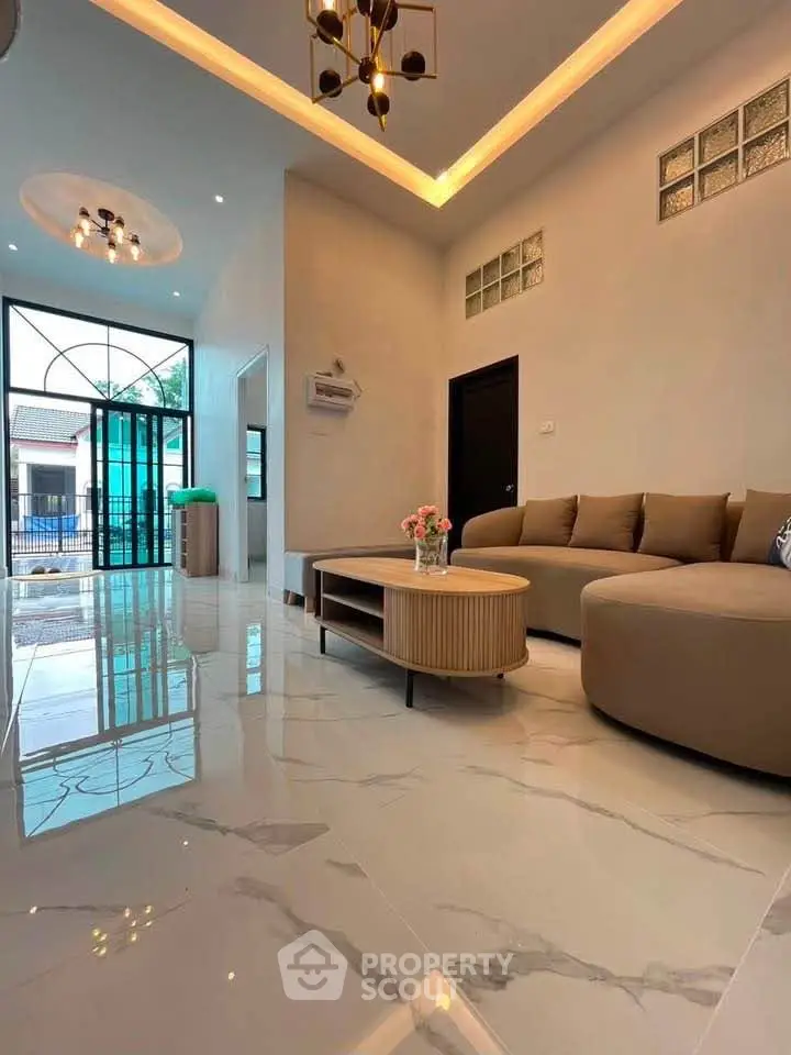 Spacious modern living room with elegant lighting and stylish furniture, perfect for relaxation and entertaining.