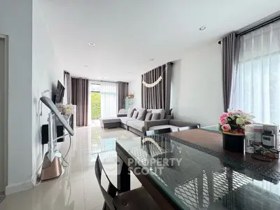 Spacious living room with modern decor and large windows for natural light.