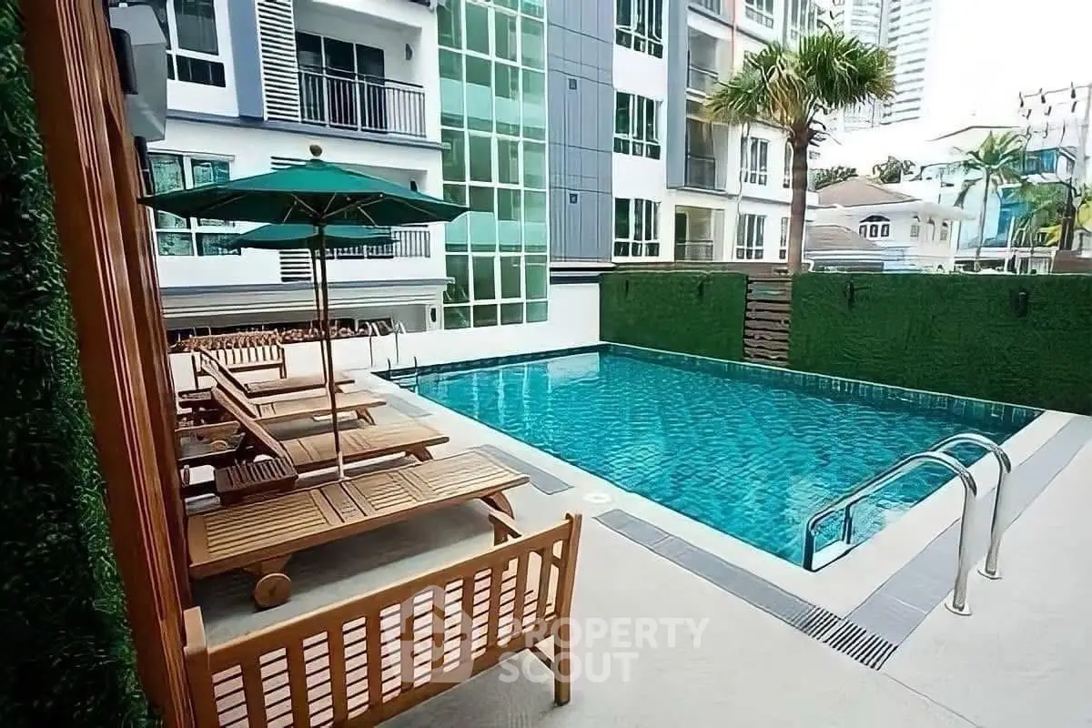 Luxurious apartment complex with a pristine swimming pool and modern amenities.
