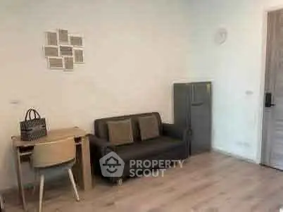 Cozy living room with modern decor and compact furniture setup.