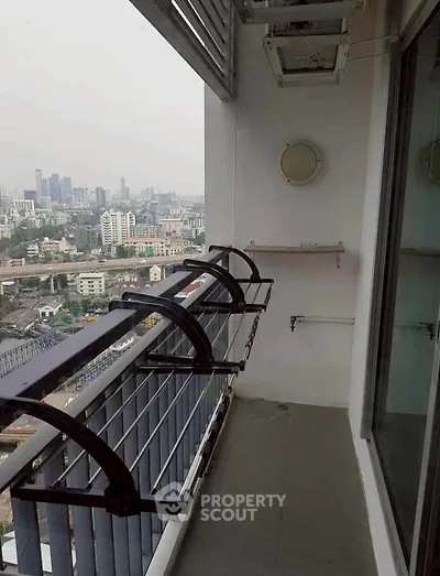 Spacious balcony with city view in modern high-rise apartment