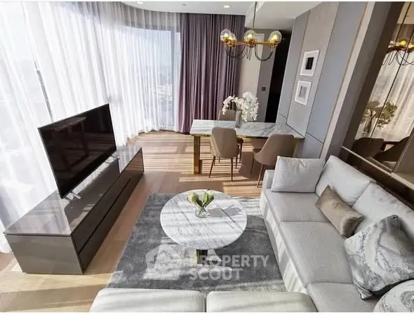 Luxurious modern living room with elegant decor and large windows offering stunning views.