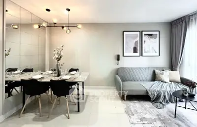 Modern living room with stylish dining area and cozy sofa, featuring elegant decor and ample natural light.