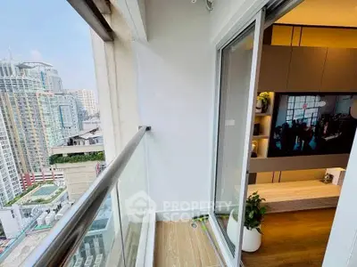 Modern balcony with city view and sliding glass doors leading to stylish interior.