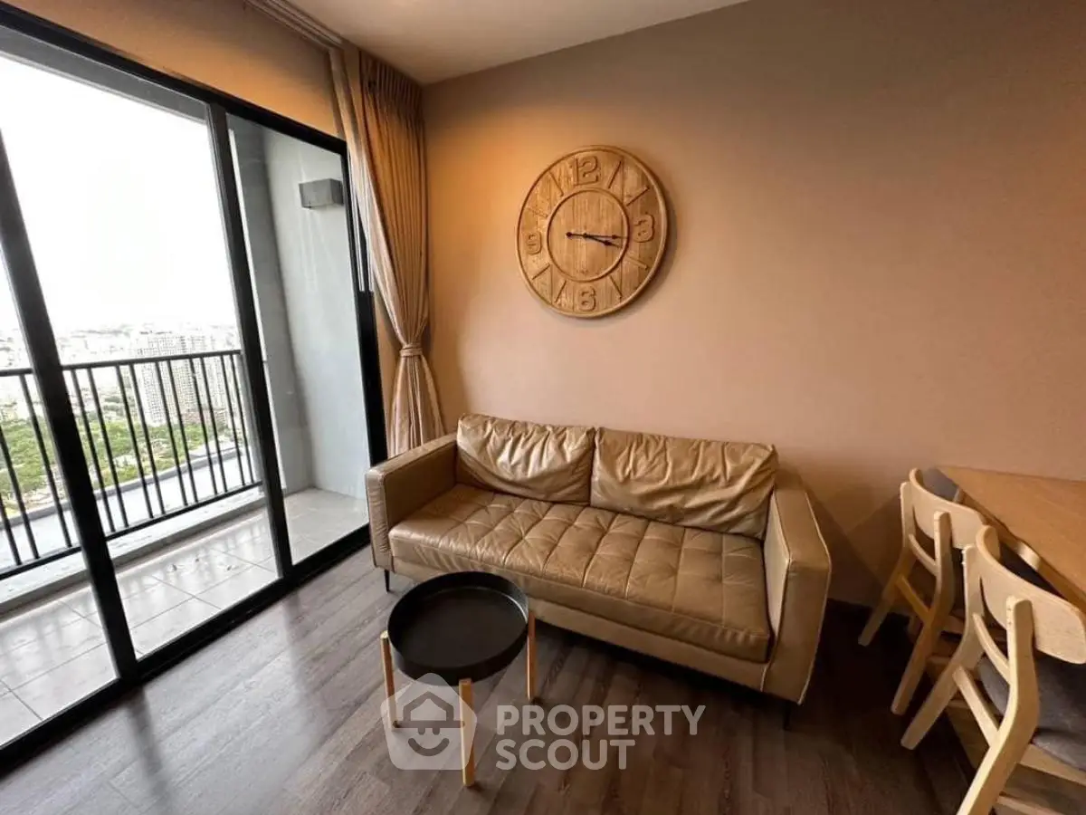 Modern living room with leather sofa and balcony view in stylish apartment