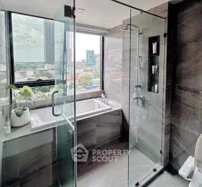 Luxurious bathroom with city view, featuring a glass shower and bathtub, perfect for relaxation.