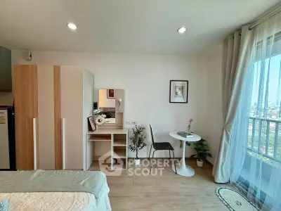 Modern studio apartment with stylish decor and city view, featuring a cozy bed, wardrobe, and dining area.