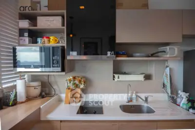 Modern kitchen with sleek cabinetry and built-in appliances, featuring a stylish open layout and contemporary design.